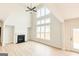 Cozy living room with fireplace and a wall of windows for natural light at 3468 Jasmine Sw Way, South Fulton, GA 30331