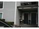 Charming townhome entrance featuring a cozy porch with seating and a decorative front door at 1602 Riverbend Club Drive, Atlanta, GA 30339