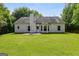 The back of this home features a lawn and patio at 305 Overland Trl, Temple, GA 30179
