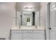 Bathroom featuring a double sink vanity with storage and modern lighting fixtures at 305 Overland Trl, Temple, GA 30179