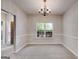 Dining room with carpet, chair rail detail, and a large window at 305 Overland Trl, Temple, GA 30179