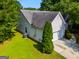 This home has vinyl siding, a two-car garage, and a lawn at 305 Overland Trl, Temple, GA 30179