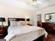 Relaxing bedroom featuring a ceiling fan, dark wood furniture and neutral decor at 8180 Chapman Ter, Mcdonough, GA 30252