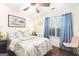 Cozy bedroom with wood floors, a bed with floral bedding, and curtains framing the window at 8180 Chapman Ter, Mcdonough, GA 30252