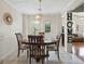 Sunlit dining room featuring stylish light fixture and backyard access at 8180 Chapman Ter, Mcdonough, GA 30252
