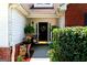 Inviting front porch adorned with lush greenery, flowers, and a decorative wreath, creating a welcoming entrance at 8180 Chapman Ter, Mcdonough, GA 30252