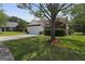 Traditional home with a spacious lawn, mature tree, and an attached two-car garage providing ample parking at 8180 Chapman Ter, Mcdonough, GA 30252
