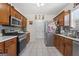 Functional kitchen featuring stainless steel appliances, mosaic backsplash, and tile flooring at 8180 Chapman Ter, Mcdonough, GA 30252