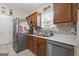 Kitchen view featuring modern stainless steel appliances and mosaic backsplash at 8180 Chapman Ter, Mcdonough, GA 30252