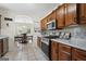 Well-equipped kitchen featuring stone countertops, stainless steel appliances, and adjoining dining area at 8180 Chapman Ter, Mcdonough, GA 30252