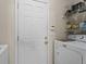 Convenient laundry room area with washer, dryer, and storage shelves at 8180 Chapman Ter, Mcdonough, GA 30252