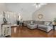 Open-concept living room with hardwood floors and a ceiling fan at 8180 Chapman Ter, Mcdonough, GA 30252