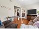 Cozy living room featuring gleaming hardwood floors, neutral paint, and an open floor plan at 8180 Chapman Ter, Mcdonough, GA 30252