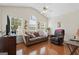 Cozy living room with hardwood floors, vaulted ceilings, and large windows for natural light at 8180 Chapman Ter, Mcdonough, GA 30252