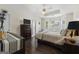 Serene main bedroom featuring a trey ceiling, hardwood floors, and bright bay windows at 8180 Chapman Ter, Mcdonough, GA 30252