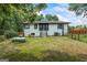 Rear view of home featuring white siding, a spacious yard and a classic design at 98 Maddox Dr, Mcdonough, GA 30252