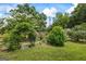 Beautiful yard with an archway and garden leading to a partially obstructed home at 98 Maddox Dr, Mcdonough, GA 30252