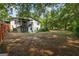 Spacious backyard with mature trees and landscaping around the perimeter at 98 Maddox Dr, Mcdonough, GA 30252