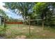 Large, partially shaded backyard featuring a metal framework structure ready for customization at 98 Maddox Dr, Mcdonough, GA 30252