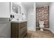 Nicely appointed bathroom featuring a stylish vanity, modern fixtures, and a glass-enclosed shower with decorative brick at 98 Maddox Dr, Mcdonough, GA 30252