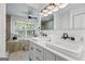 Bright bathroom featuring double sinks, stone tile accents, and modern fixtures at 98 Maddox Dr, Mcdonough, GA 30252