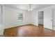 Bright bedroom featuring hardwood floors, a window, and a closet or door to another room at 98 Maddox Dr, Mcdonough, GA 30252