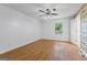 Bright bedroom with hardwood floors, ceiling fan, and window with natural light at 98 Maddox Dr, Mcdonough, GA 30252