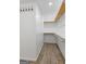 An ample walk-in closet with custom shelving and hardwood floors at 98 Maddox Dr, Mcdonough, GA 30252