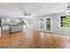 Spacious living room featuring hardwood floors, ceiling fan, and access to an outdoor balcony at 98 Maddox Dr, Mcdonough, GA 30252