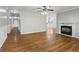 Inviting living room with hardwood floors, ceiling fan, fireplace, and neutral paint scheme at 98 Maddox Dr, Mcdonough, GA 30252