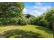 Cozy outbuilding surrounded by lush greenery and mature trees at 98 Maddox Dr, Mcdonough, GA 30252