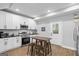 Well-lit kitchen with white cabinets, stainless steel appliances, and a central island with seating at 1174 Princess Sw Ave, Atlanta, GA 30310