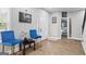 Inviting sitting room featuring bright blue chairs, artwork, and access to other rooms at 1174 Princess Sw Ave, Atlanta, GA 30310