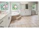 Bright bathroom featuring a soaking tub with decorative trim and a large vanity with double sinks at 150 Old Plantation Way, Fayetteville, GA 30214