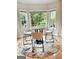 Bright breakfast nook with a round table, modern chairs, and large windows offering serene views at 150 Old Plantation Way, Fayetteville, GA 30214