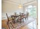 Elegant dining room features a decorative chandelier, hardwood floors, and large windows at 150 Old Plantation Way, Fayetteville, GA 30214