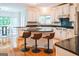 Spacious kitchen with white cabinets, granite countertops, stainless steel appliances, and a breakfast bar at 150 Old Plantation Way, Fayetteville, GA 30214