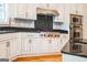 Updated kitchen features stainless steel appliances, granite countertops, and white custom cabinetry at 150 Old Plantation Way, Fayetteville, GA 30214