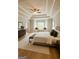 Luxurious main bedroom suite with tray ceilings, bay window seat, and hardwood floors at 150 Old Plantation Way, Fayetteville, GA 30214