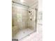 Elegant shower with a glass door and tiled walls, showcasing a neutral color palette at 150 Old Plantation Way, Fayetteville, GA 30214