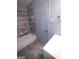 Neat bathroom showing the tub/shower combination with tiled wall, vanity, and tiled floor at 187 Peyton Sw Pl, Atlanta, GA 30311