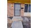 Townhome brick exterior featuring a secured front door and a step-up walkway entrance at 187 Peyton Sw Pl, Atlanta, GA 30311
