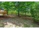 Landscaped backyard with deck and mature trees at 438 Punkintown Rd, Villa Rica, GA 30180