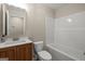 Full bathroom with tub, toilet, wood vanity, and framed mirror at 438 Punkintown Rd, Villa Rica, GA 30180