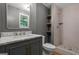 Updated bathroom featuring a modern vanity, walk-in shower, and open shelving at 438 Punkintown Rd, Villa Rica, GA 30180