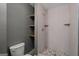 Modern tiled shower with pebble floor and corner shelves at 438 Punkintown Rd, Villa Rica, GA 30180