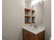 Bathroom with wood vanity and framed mirror with wooden shelves at 438 Punkintown Rd, Villa Rica, GA 30180