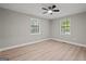 Bright bedroom with laminate floors and two well-lit windows at 438 Punkintown Rd, Villa Rica, GA 30180