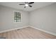 Neutral bedroom featuring new wood floor and a ceiling fan at 438 Punkintown Rd, Villa Rica, GA 30180