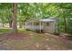 Charming home nestled among mature trees, featuring a well-maintained front yard and cozy exterior at 438 Punkintown Rd, Villa Rica, GA 30180